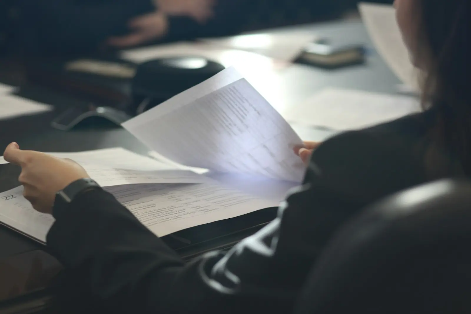 Personne relisant des documents juridiques à son bureau